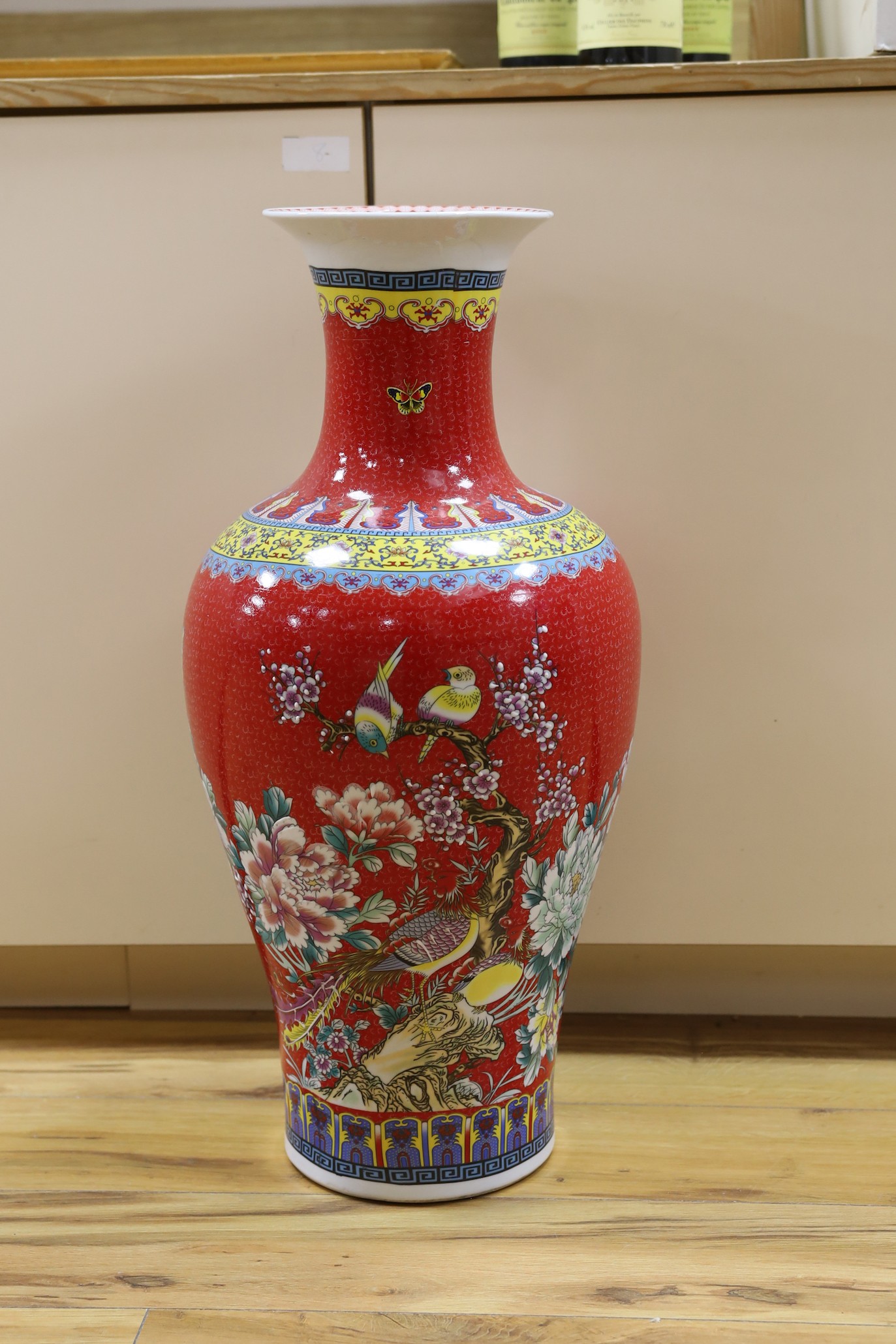 A large modern red ground Chinese vase with floral decoration - 68.5cm tall